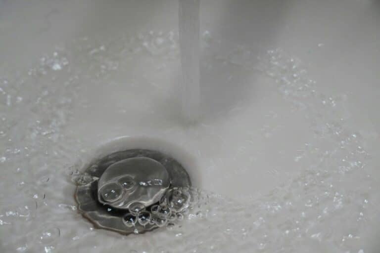 a close up of a sink with water running down it